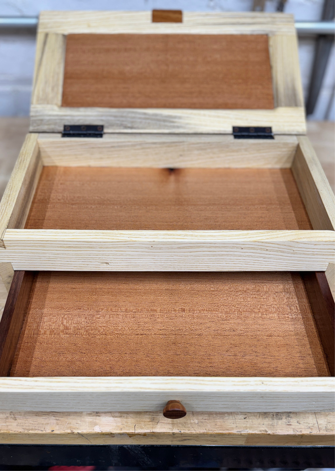 Wooden jewelry box with 'Collins & Co' engraving on a blurred background