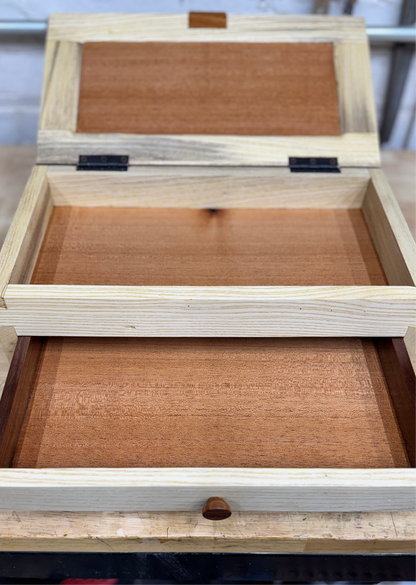 Wooden jewelry box with 'Collins & Co' engraving on a blurred background